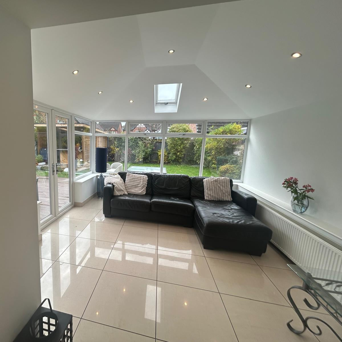 Modern interior living room with plastered vaulted ceiling and spotlights