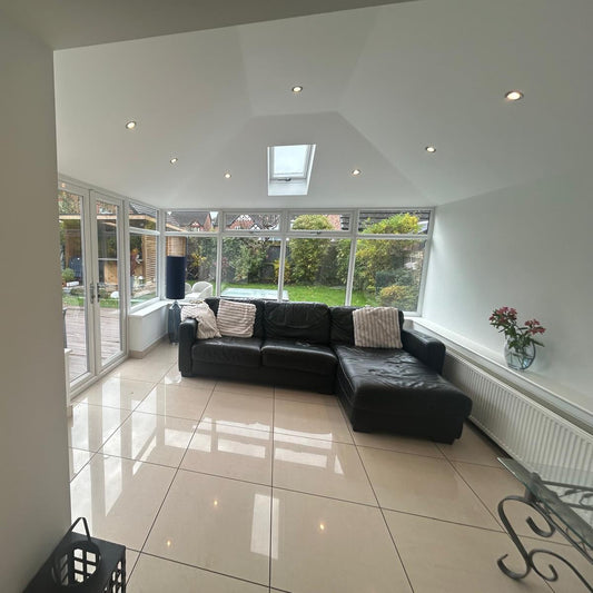 Modern interior living room with plastered vaulted ceiling and spotlights